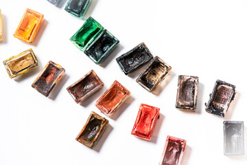 Set of watercolor paints and paintbrushes for painting closeup. Selective focus.