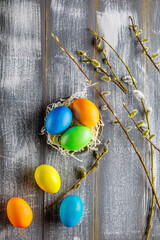 easter still life with colorful easter eggs on wooden background