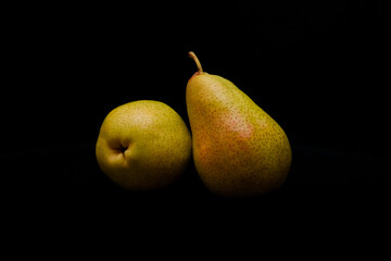 Fototapeta na wymiar Two ripe pears on dark background