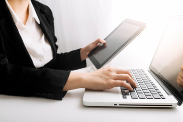 businesswoman hand using smart phone, tablet payments and holding credit card online shopping, omni channel, digital tablet docking keyboard computer at office in sun light