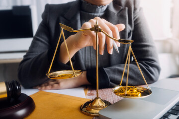 Business and lawyers discussing contract papers with brass scale on desk in office. Law, legal services, advice, justice and law concept picture with film grain effect