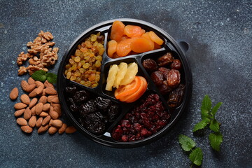 Mix of dried and sun-dried fruits,  in a wooden trays . View from above. Symbols of the Jewish holiday of Tu BiShvat