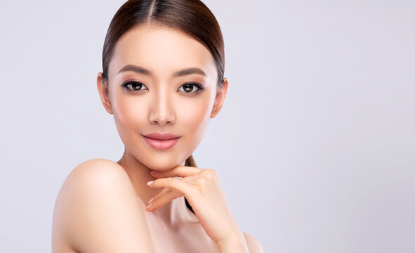 Beautiful young asian woman with Clean Fresh Skin on face . Chinese girl Facial  treatment . Cosmetology , beauty  and spa .