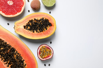 Fresh ripe papaya and other fruits on white background, top view