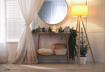 Stylish room interior with mirror and wooden console table near wall