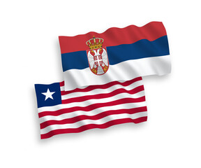 National vector fabric wave flags of Liberia and Serbia isolated on white background. 1 to 2 proportion.