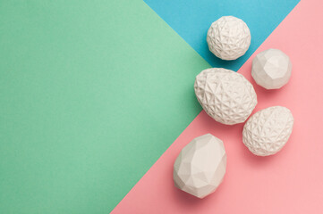 White Easter eggs with geometric patterns on color blocks background