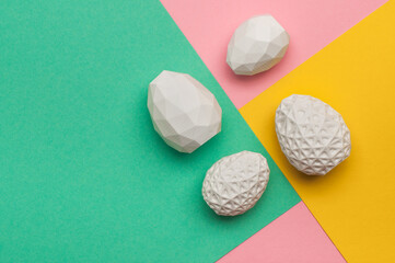 Easter eggs with geometric patterns on color blocks yellow, green and pink background