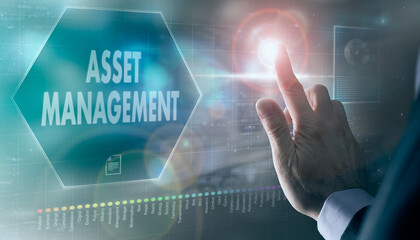 A businessman controlling a futuristic display with a Asset Management business concept on it.