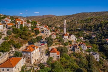 Village Lozisca at sunset hour. Island Brac, Croatia. August 2020. Aerial drone view.