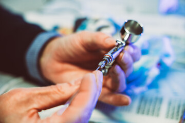 Man painting with airbrushing a work of art