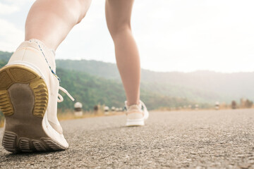 woman legs,running on empty road