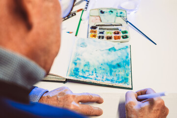 Man painting with airbrushing a work of art