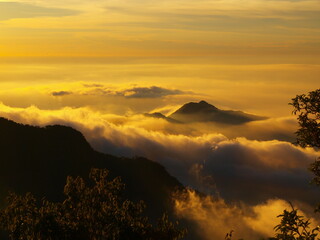 high altitude mountains with clouds like sea, at sunset