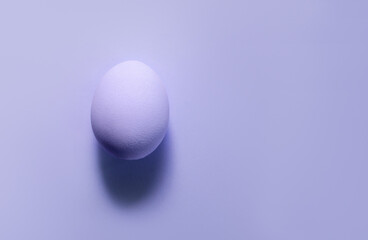Purple pastel simple Easter background. Modern Fashion easter egg pattern minimalism. Top view. Trendy screensaver holiday postcard. Beautiful food. Place for text copyspace. One color 