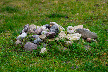 Fototapeta premium Pile of rocks grown in the grass.