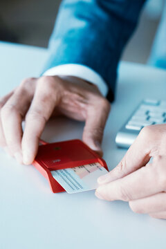 man inserting an electronic identification in a reader