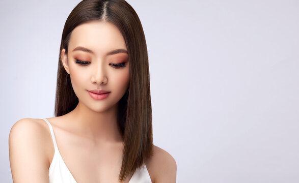 Beautiful Asian woman with  straight hair. Beauty Chinese  girl with clean and white skin. Fashion, cosmetics and makeup