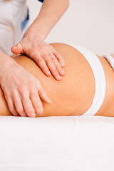 Fototapeta na wymiar massage on the buttocks