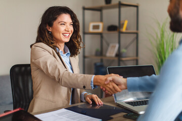 Young woman signing contracts and handshake with a manager - Powered by Adobe