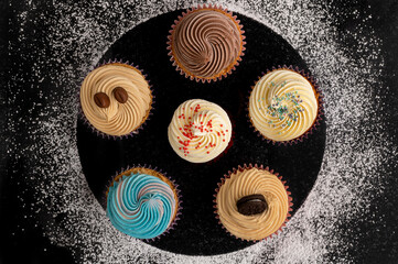 cupcakes with different tastes on a black background