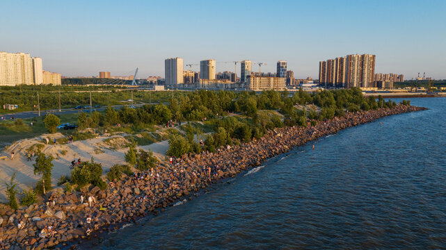 Saint-Petersburg. The beach near the new buildings of the Parusa residential complex. People relax on the beach.