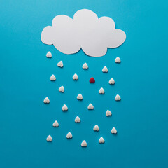 Cloud and rain in shape of hearts with one red drop.  Minimalist concept.