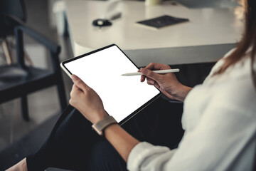 Businesswoman using a pen to taking notes on digital tablet at office. blank white screen.