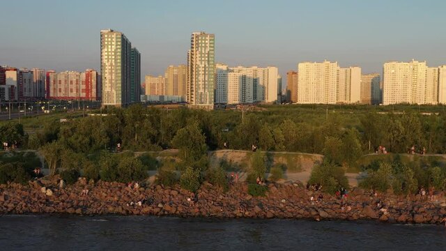 Saint-Petersburg. The beach near the new buildings of the Parusa residential complex. People relax on the beach.