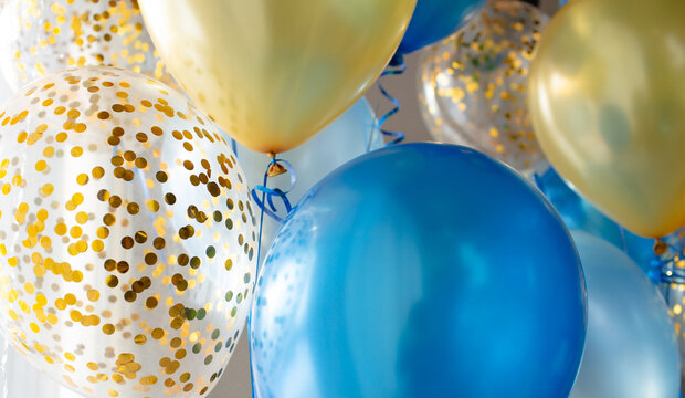 Fototapeta Blue and transparent balloons with golden confetti on the background of a large window. Light interior 