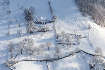 Winter frosty landscape of the beautiful Transylvanian village, Bran, with fresh snow, at the foot of the Carpathian Mountains