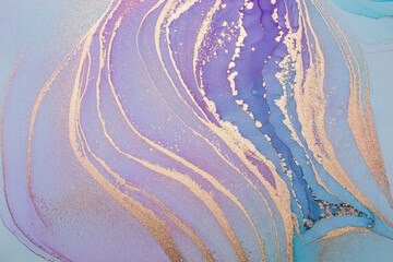 Luxury abstract fluid art painting in alcohol ink technique, mixture of blue and purple paints.  Imitation of marble stone texture, glowing golden veins. Tender and dreamy design. 