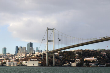 Naklejka premium The Bosphorus Bridge, thus connecting Europe and Asia (alongside Fatih Sultan Mehmet Bridge and Yavuz Sultan Selim Bridge). The bridge extends between Ortaköy (in Europe) and Beylerbeyi (in Asia).