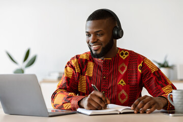 Distance Learning. Happy Black Millennial Guy Study Online With Laptop And Headset