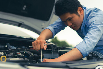 The male mechanic's hand holds the wrench In order to fix And check car engine, engineer concept and car repair