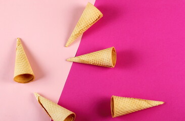 Emty Ice cream cones pattern on pink background. Top view. Several wafer ice cream cones designe