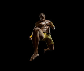 Fototapeta na wymiar Thai boxer on boxing ring, jump and kicking