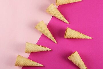 Emty Ice cream cones pattern on pink background. Top view. Several wafer ice cream cones designe