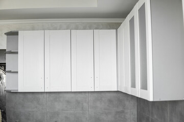 Custom kitchen cabinets installation with a white furniture facades mdf. Gray modular kitchen from...