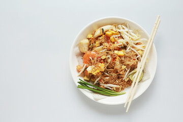 Pad Thai stir fried noodle Thai style with pork tofu and vegetable on plate put on white background , The favorite food in Thailand 