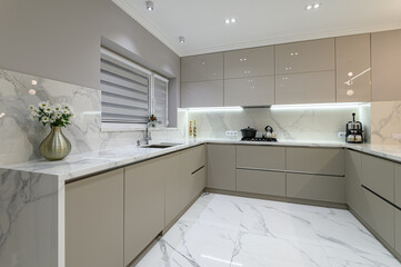 Luxury white modern marble kitchen in studio space - obrazy, fototapety, plakaty
