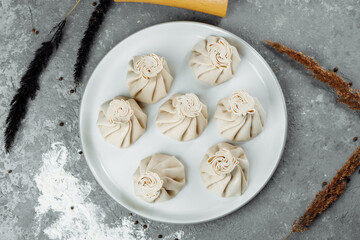 Caucasuan cuisine - Khinkali with meat on a white plate