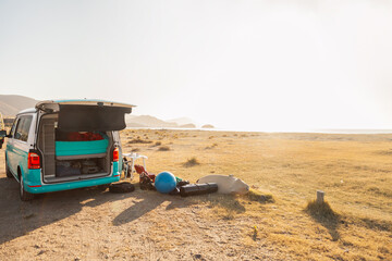Camper van parked near the sea in Almeria, Spain, with vacation objects