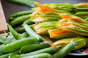 Fresh green pea pods on a wooden cutting board. Selective focus on object.