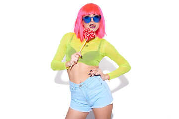 Fashion girl in pink wig lick lollipop and show tongue on white isolated background