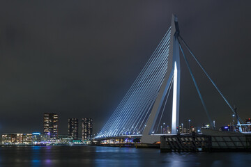 Fototapeta na wymiar Rotterdam skyline at night, river view and illuminated bridge...