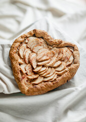Heart shaped apple pie on linen cloth for St. Valentine's Day 