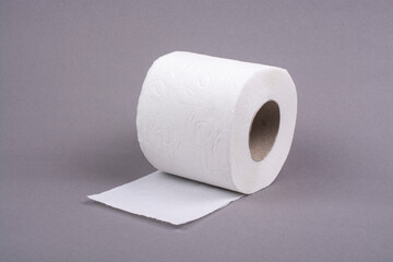 Roll of toilet paper on a gray background.