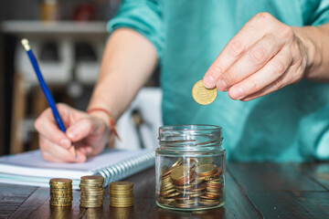 A woman saves money for her future personal projects.
