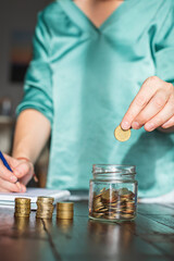 A woman saves money for her future personal projects.
